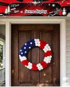 Scene detail shot of American patriotic pom pom wreath hanging on wooden door for home holiday decor.