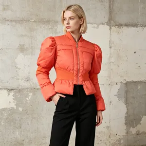 Close-up detail of the stylish orange puffer jacket featuring chic puff sleeves and slim fit.