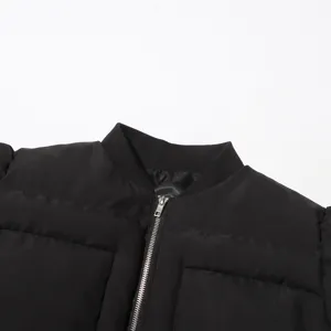 Close-up detail of a women's black puffer jacket featuring a stand collar and zipper.