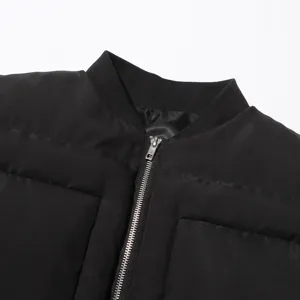 Closeup detail of a black winter cotton coat collar and metal zipper. Premium apparel craft.
