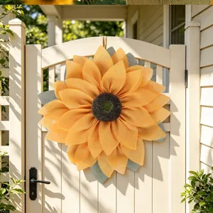 Detailed view of large fabric sunflower wreath hanging on wooden gate for autumn decor.