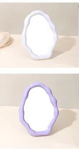 Detailed view of the irregular cloud makeup mirror with white and purple plastic wavy frames.