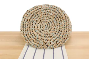 Vue détaillée du sac à bandoulière rond en paille tissée avec fil bleu, style plage.