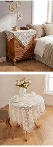 Beige crochet lace tablecloth with tassels, vintage hollow knit table cover for home decor.