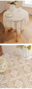 Vintage beige knit lace round tablecloth with tassels for elegant living room table decor.