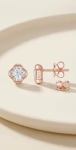 Close-up detail of S925 silver moissanite four-leaf clover stud earrings in rose gold finish.