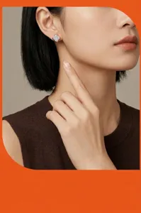 Close-up detail of silver moissanite clover stud earrings worn by model, elegant style.