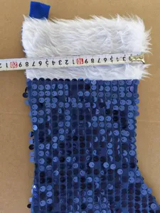 Blue sequin Christmas stocking detail showing white faux fur cuff and clear size measurement.