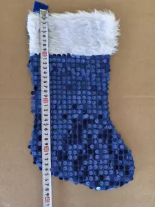 Blue sequin Christmas stocking with white plush cuff, festive holiday decoration hanging.