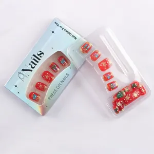 Uñas postizas cuadradas cortas, diseño navideño rojo brillante con motivos de regalos y estrellas.