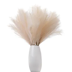 Artificial pampas grass faux reed floral arrangement with white ceramic vase home decor.