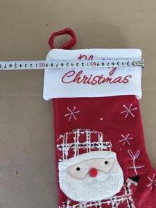Christmas stocking gift bag with cute Santa Claus design and hanging loop detail.