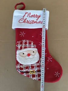 Red Christmas stocking with Santa Claus applique and Merry Christmas embroidery for holiday decor.