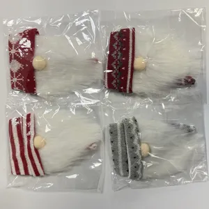 Detailed close-up view of knitted Christmas gnome hat bottle covers featuring soft plush beards.