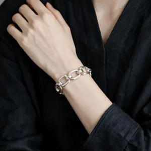 Close-up detail shot of a chunky silver geometric chain bracelet showcasing stylish retro punk design.