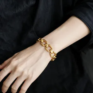 Chunky gold-toned geometric link bracelet detailed shot, elegant wrist jewelry for daily wear.