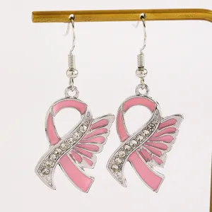 Detailed view of pink ribbon awareness hook earrings with rhinestones and wings for charity support.