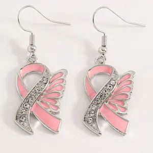 Detail view of pink ribbon angel wing rhinestone earrings, elegant alloy jewelry for awareness.