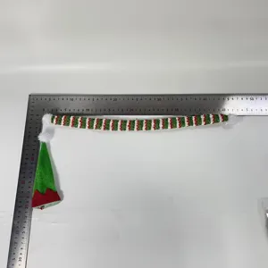 Mini set di copribottiglia di vino natalizio con cappello verde e sciarpa a righe.