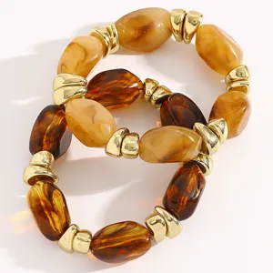 Detailed close-up of retro resin and gold-tone beaded bracelet set, chic and stylish design.