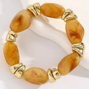 Detail closeup of the vintage amber resin and gold metallic bead stretch bracelet.