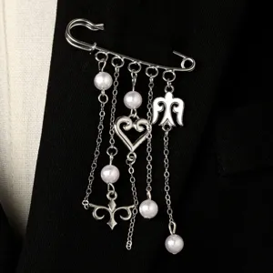Silver brooch detail, elegant pearl and chain pendant design, ethnic style accessory for women.