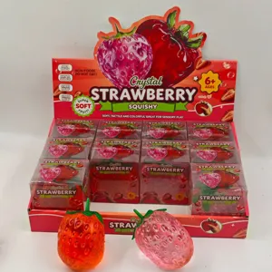 Detailed close-up view of crystal strawberry squishy toy display box, soft stress relief toy.