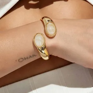 Gold wide cuff bracelet with oval stone minimalist chic jewelry accessory piece