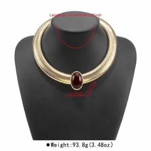 Detail view of the wide snake chain choker necklace with an oval red gemstone accent.