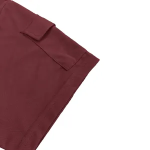 Close-up detail of burgundy men's short-sleeve t-shirt sleeve and pocket design.
