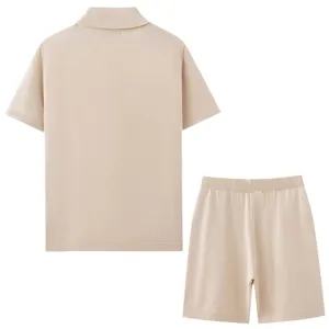 Detail view of men's beige knitted short sleeve polo shirt and matching casual shorts set.