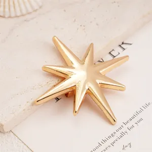 Gold polished eight-pointed star brooch pin, stylish fashion jewelry accessory for apparel.