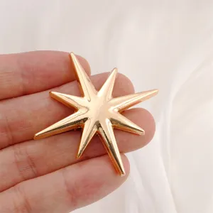 Gold-toned eight-pointed star brooch alloy fashion clothing accessory star pin detail shot