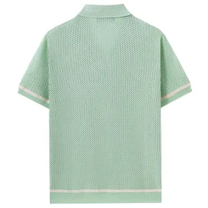 Men's light green knit hollow short sleeve polo shirt detail showing texture and cuffs.