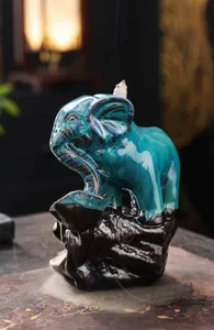 Ceramic elephant backflow incense burner detail shot, elegant blue glaze texture and smoke effect.