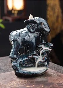 Elephant backflow incense burner detail, ceramic purple clay handicraft for home decor.