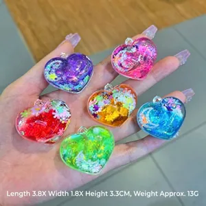 Detailed shot of colorful heart-shaped liquid keychains, transparent resin charm with glitter.