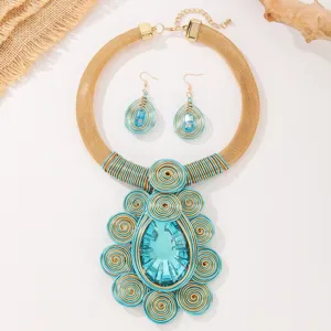 Close-up detail of handmade blue crystal wire wrapped statement necklace earrings jewelry set.