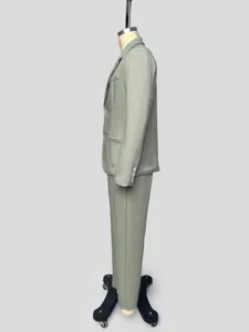 Detail view of men's solid color suit jacket and trousers side profile on mannequin.