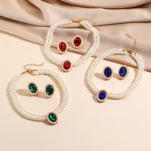 Detailed view of vintage multi-layer faux pearl choker necklace and matching crystal earrings.