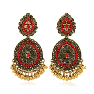 Exquisite Indian ethnic vintage drop earrings featuring intricate carving, red rhinestones and beads.