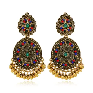 Detailed shot of vintage ethnic gold-toned alloy dangling earrings with colorful rhinestones.