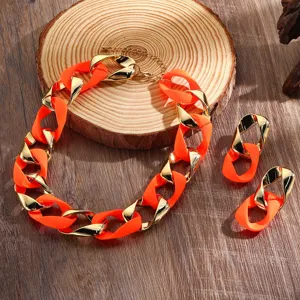 Neon orange and gold chunky chain necklace and earrings set, stylish fashion jewelry details.