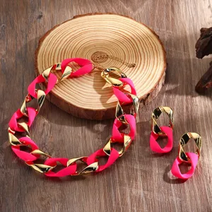 Neon pink and gold chunky chain necklace and matching earrings set for women, detailed view.