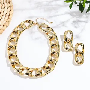Gold chunky chain necklace and geometric earrings set, trendy fashion jewelry details close up.