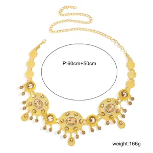 Detail shot of golden metal waist chain with sparkling crystal rhinestones and chic tassels.
