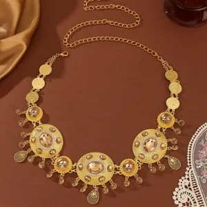 Close-up detail of Middle Eastern style gold waist chain with oval crystal and tassel.