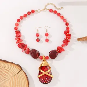 Red crystal teardrop pendant necklace earrings set detail, chic boho jewelry accessory.