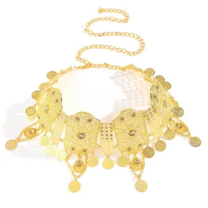 Middle Eastern gold waist chain detail, cutout carved metal plates and coin tassels.