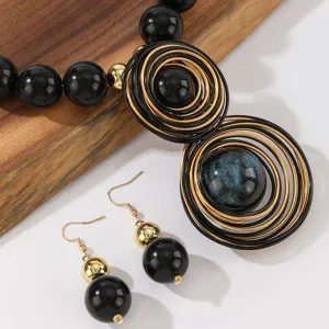 Handmade black and gold aluminum wire resin bead necklace and earrings jewelry set detail view.